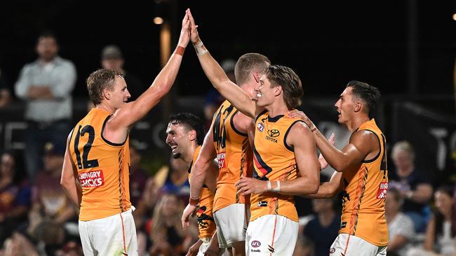 IPSWICH, AUSTRALIA - FEBRUARY 27: Isaac Cumming of the Crows celebrates with team mates after kicking a goal during the 2025 AAMI AFL Community Series match between Brisbane Lions and Adelaide Crows at Brighton Homes Arena on February 27, 2025 in Ipswich, Australia. (Photo by Bradley Kanaris/Getty Images)