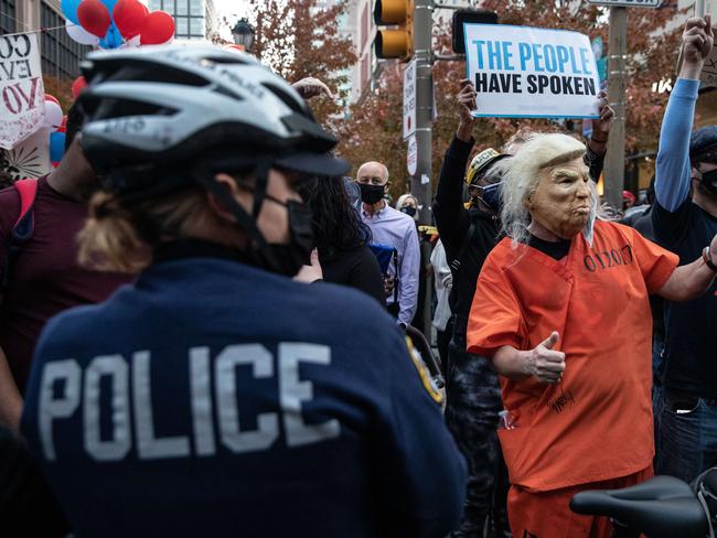 ‘The people have spoken’. A demonstrator wearing a Donald Trump mask in Philadelphia, Pennsylvania. Picture: AFP