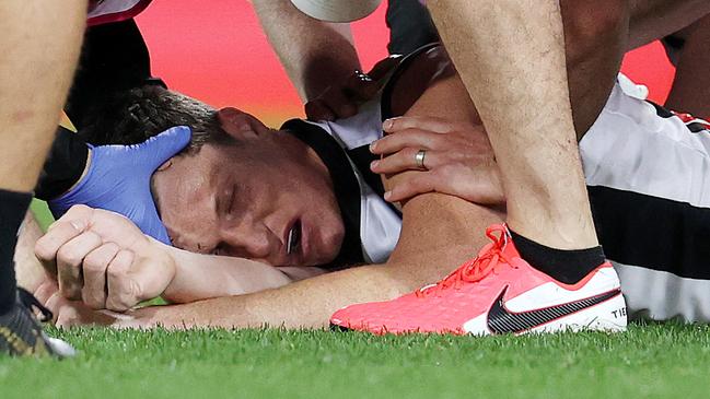 The Gabba crowd remained silent as Collingwood forward Brody Mihocek was treated by several medics after a “horrific” head knock.