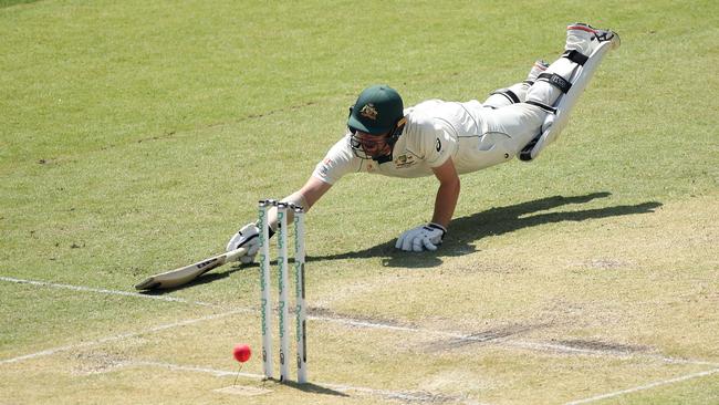 Travis Head scrambles to make his ground. Picture: Getty Images