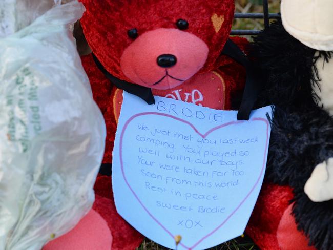 Flowers and toys adorn the front fence of the home. Picture: Lawrence Pinder