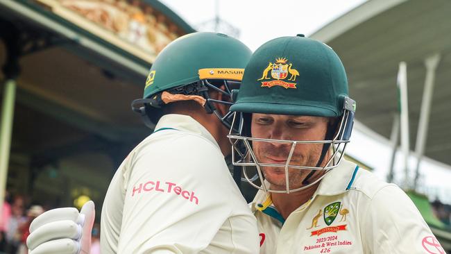 Warner and Usman Khawaja embrace before heading out to bat. Picture: Getty Images