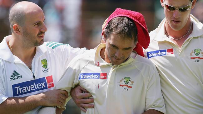 Justin Langer is helped from the field after being struck in the head by a delivery from South Africa’s Makhaya Ntini at Wanderers Stadium in 2006