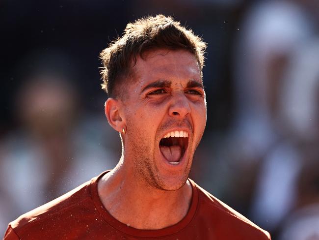 TOPSHOT - Australia's Thanasi Kokkinakis celebrates his victory over Switzerland's Stan Wawrinka during their men's singles match on day four of the Roland-Garros Open tennis tournament at the Court Simonne-Mathieu in Paris on May 31, 2023. (Photo by Anne-Christine POUJOULAT / AFP)