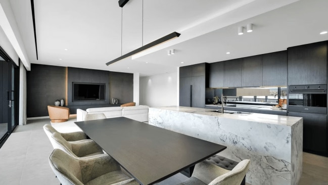 Jacqui and Clint's home boasts eight key features, including a tennis court, golf simulator, theatre, gym, bar and entertaining area, paved driveway, stone bench tops, and double vanities. Picture: Zanetto Builders/Supplied