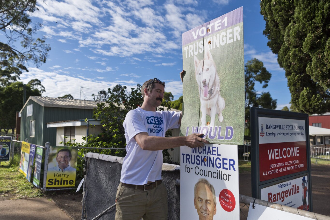 Cameron Truskinger sets up a corflute sign as the Rangeville State School booth opens on Toowoomba Regional Council local government election day, Saturday, March 28, 2020. Picture: Kevin Farmer