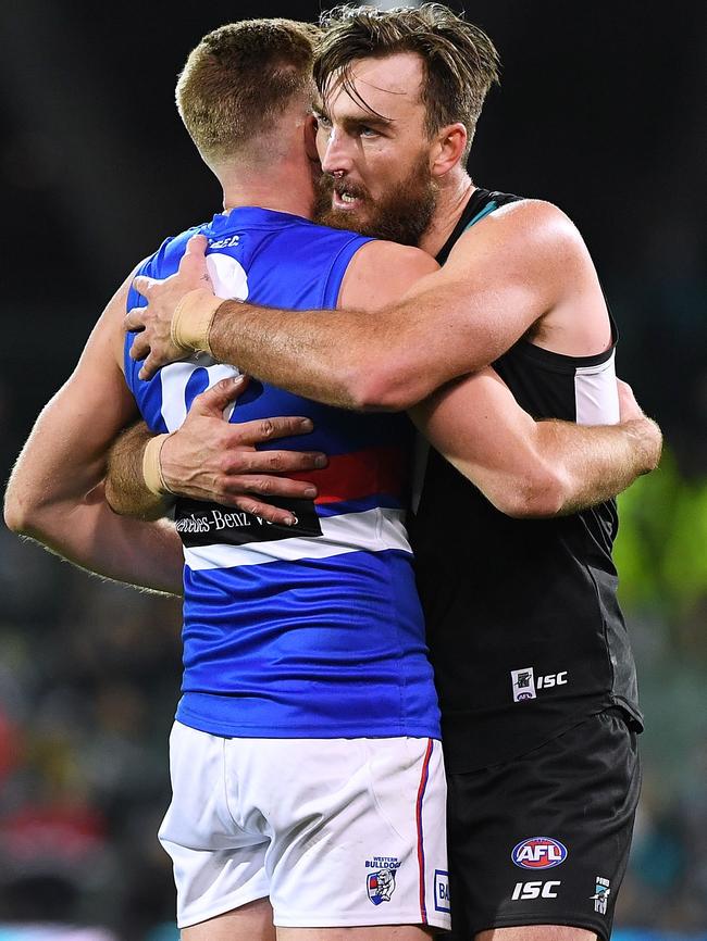 Charlie Dixon of Port Adelaide hugs former team mate Jackson Trengove of the Bulldogs after their round 13 clash. Picture: Mark Brake/Getty Images