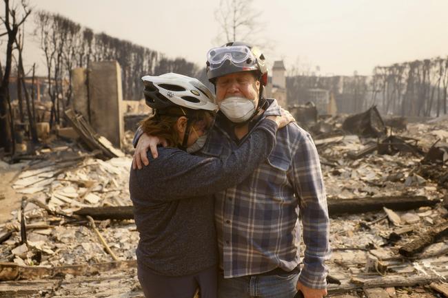 Claudio and Kathleen Boltiansky embrace in their fire-ravaged neighbourhood of Pacific Palisades. Picture: AP