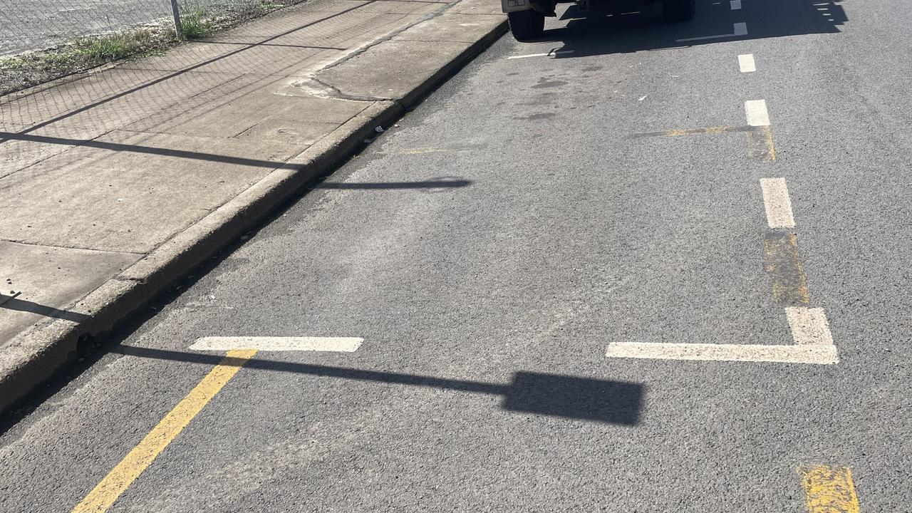 A park on Richmond St where car park lines overlap yellow loading zone indicators.