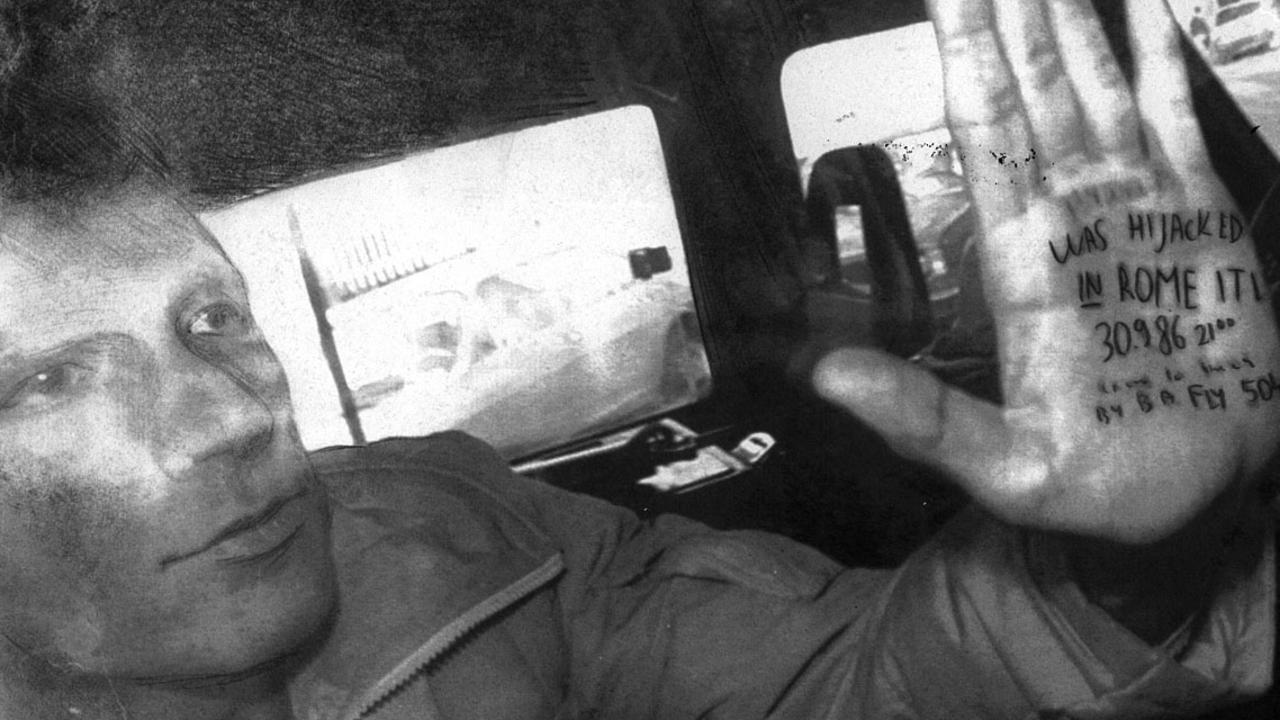 Mordechai Vanunu in a police van with a message written on his hand. Picture: Supplied