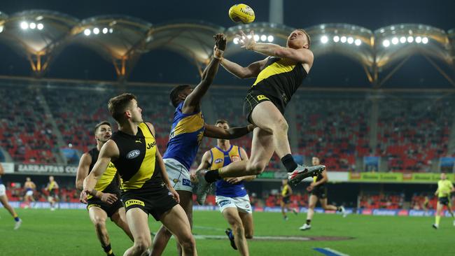 Nick Vlastuin flies high for Richmond in attempt to take a mark against West Coast Eagles at Metricon Stadium. Picture: Getty Images