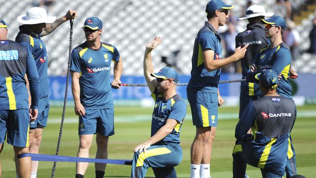 Australia's David Warner, centre, warms up with team-mates before the start of day five. Picture: AP