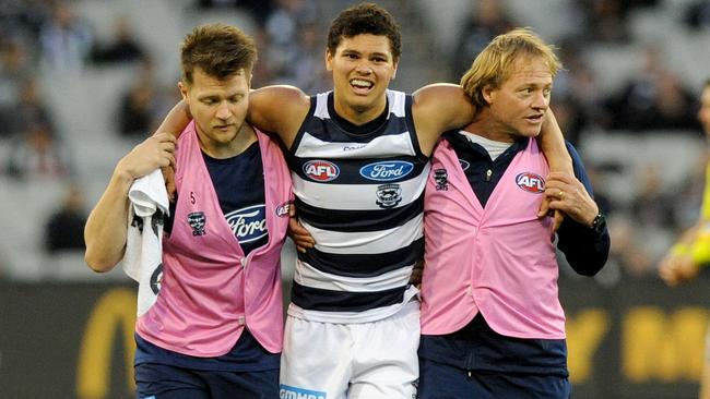 Brandan Parfitt is helped off the ground after injuring his hamstring.