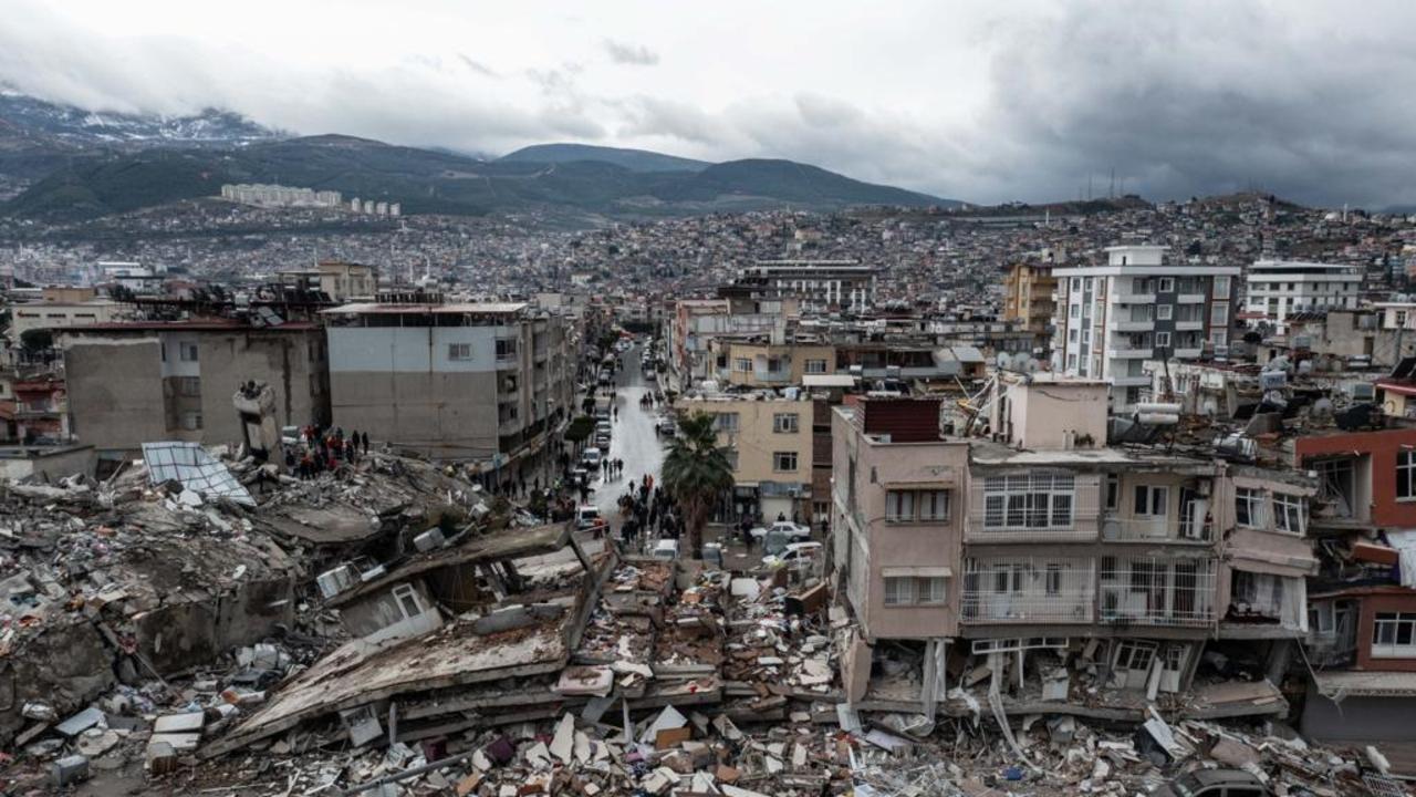 HATAY, TURKIYE - FEBRUARY 06: An aerial view of debris of a collapsed building after 7.7 magnitude earthquake hits Hatay, Turkiye on February 06, 2023. Disaster and Emergency Management Authority (AFAD) of Turkiye said the 7.7 magnitude quake struck at 4.17 a.m. (0117GMT) and was centered in the Pazarcik district in TurkiyeÃ&#131;Â¢s southern province of Kahramanmaras. Gaziantep, Sanliurfa, Diyarbakir, Adana, Adiyaman, Malatya, Osmaniye, Hatay, and Kilis provinces are heavily affected by the quake. (Photo by Murat Sengul/Anadolu Agency via Getty Images)