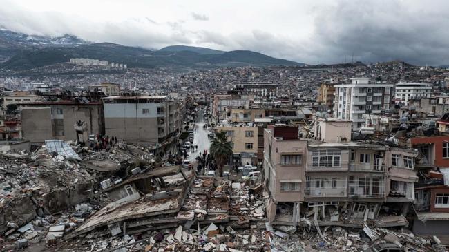 HATAY, TURKIYE - FEBRUARY 06: An aerial view of debris of a collapsed building after 7.7 magnitude earthquake hits Hatay, Turkiye on February 06, 2023. Disaster and Emergency Management Authority (AFAD) of Turkiye said the 7.7 magnitude quake struck at 4.17 a.m. (0117GMT) and was centered in the Pazarcik district in TurkiyeÃƒÂ¢s southern province of Kahramanmaras. Gaziantep, Sanliurfa, Diyarbakir, Adana, Adiyaman, Malatya, Osmaniye, Hatay, and Kilis provinces are heavily affected by the quake. (Photo by Murat Sengul/Anadolu Agency via Getty Images)
