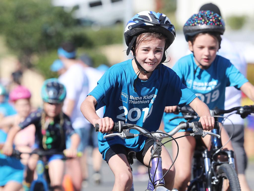 Participants competing in the Bupa KidFit Series triathlon beginning their cycling leg at Blackmans Bay Beach. Picture: LUKE BOWDEN