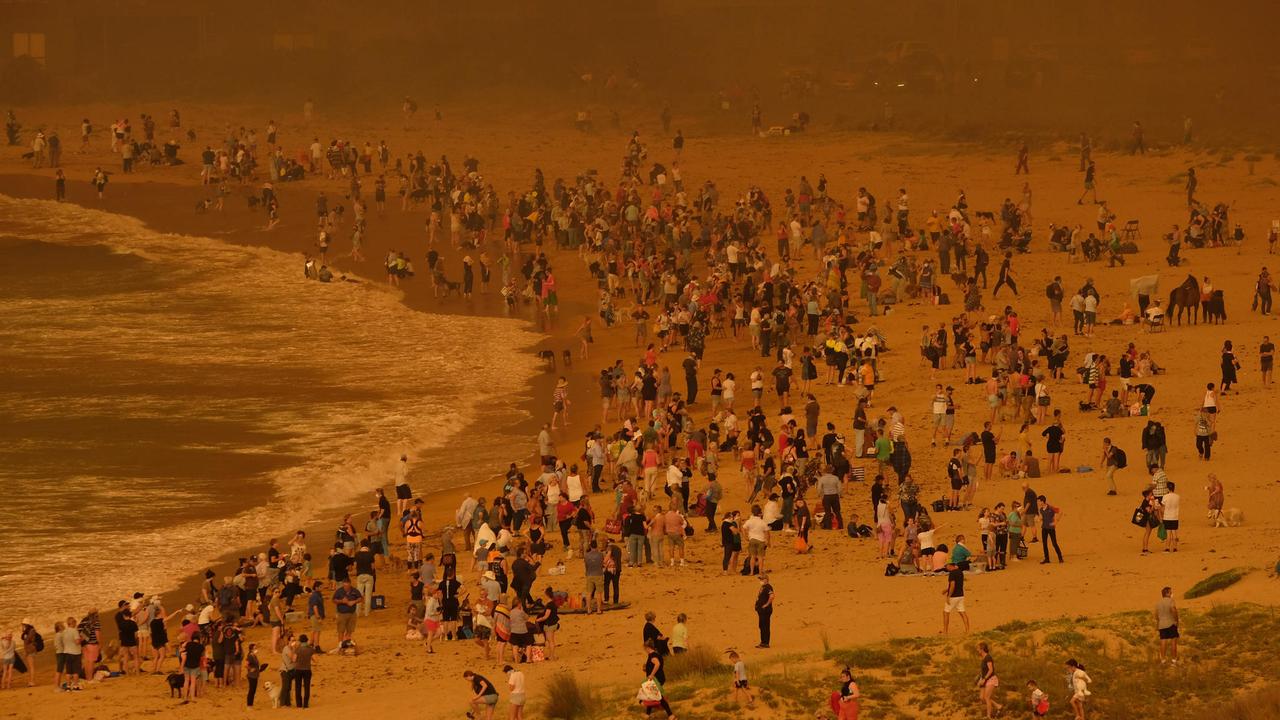 People stranded on the beach as bushfire arrives into the township of Malua Bay, north of Narooma. Picture: Alex Coppel.