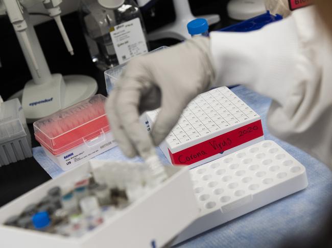 Dr. Nita Patel, Director of Antibody discovery and Vaccine development, lifts a vial with a potential COVID-19, vaccine at Novavax labs in Maryland. Picture: AFP