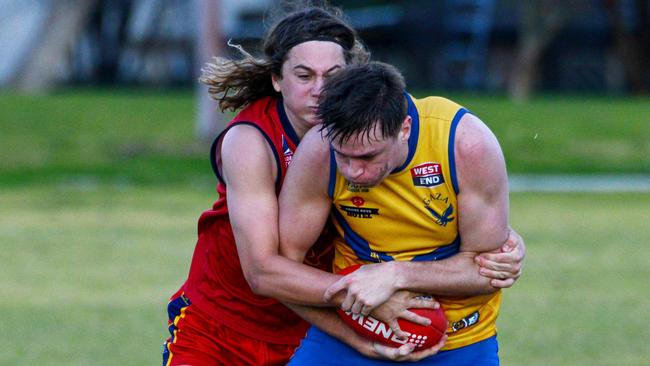 Gaza’s James Siviour is tackled by Flinders Park’s Mitchell Smart during the sides’ division three Adelaide Footy league round one match at Klemzig Oval. Picture: Brenton Edwards