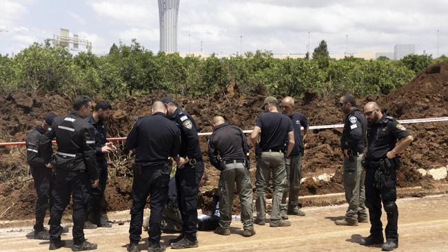 Police officers inspect a scene after a ballistic missile fired from Yemen by the Houthi struck at a field near Israel's International airport. Picture: Getty Images