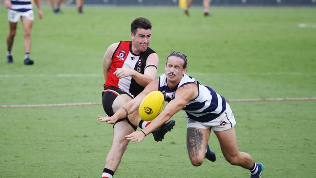 Saints' Tom Jenkins gets a kick past Crocs' Zach Beckman in the AFL Cairns seniors semi final match between the Cairns Saints and the Port Douglas Crocs, held at Cazalys Stadium, Manunda. Picture: Brendan Radke