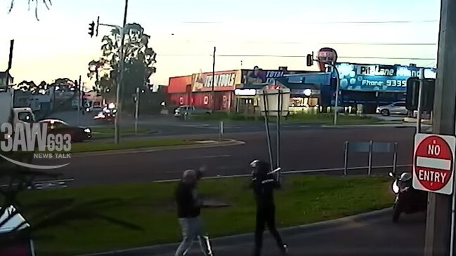 The motorbike rider swings a metal bar at the man. Picture: 3aw