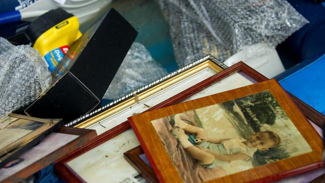 Residents of Rocklea used an inflatable boat to retrieve family photos and other prized possessions in Brisbane on Wednesday, January 12, 2011.