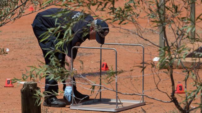 Forensic investigators analyse the scene. Photo: Jeff Tan