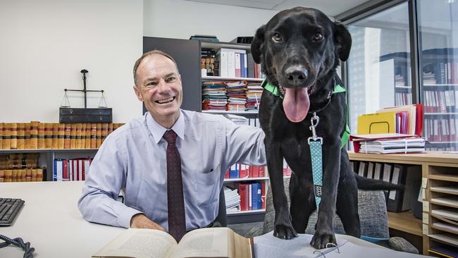 John Cain and victim support dog Coop. Picture: Jason Edwards