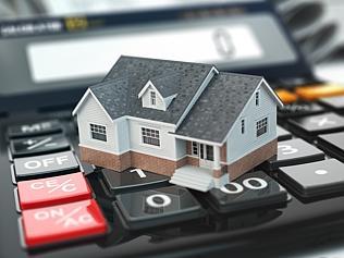 Mortgage calculator. House on buttons. Real estate concept.