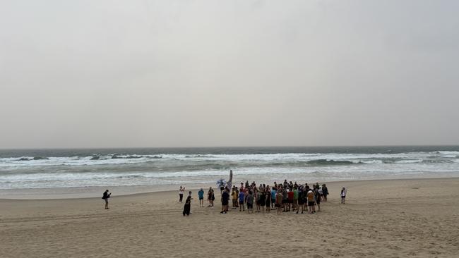 The farmers braved the rainy and windy beach to run a 3km loop from Broadbeach. Picture: Jacklyn O'Brien.