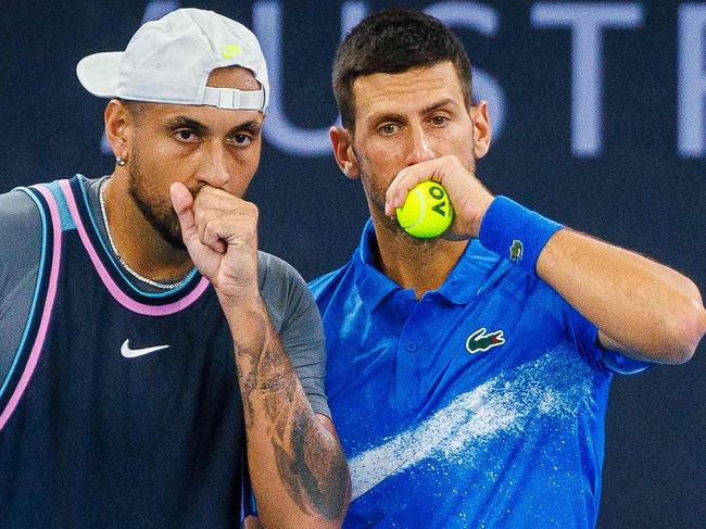 TOPSHOT - Serbia's Novak Djokovic (R) speaks with Australia's Nick Kyrgios before a point during their men's doubles match against Michael Venus of New Zealand and Nikola Mektic of Croatia at the Brisbane International tennis tournament in Brisbane on January 1, 2025. (Photo by Patrick HAMILTON / AFP) / --IMAGE RESTRICTED TO EDITORIAL USE - STRICTLY NO COMMERCIAL USE--