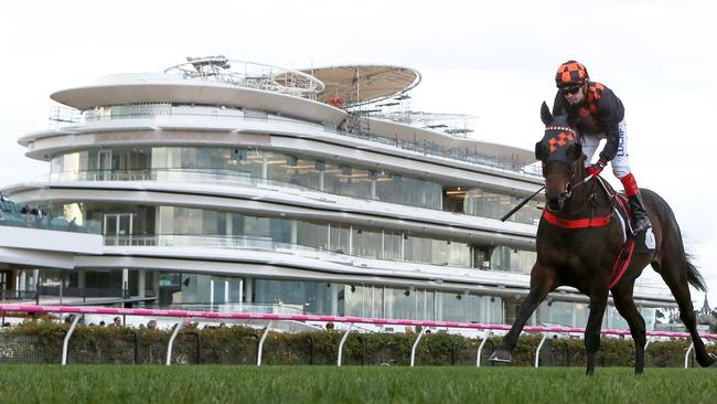 Jockey Dean Yendall rides Bondeiger past the new Club stand at Flemington on July 21. Picture: AAP/George Salpigtidis