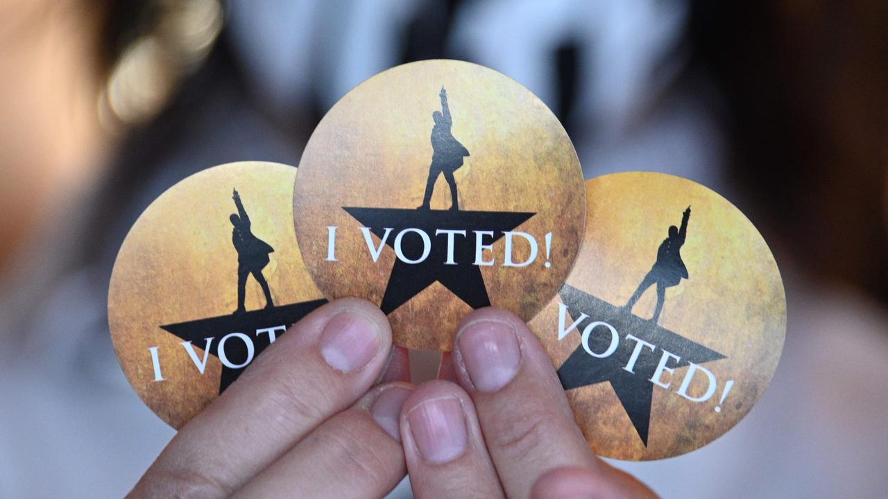 An election worker displays the "Hamilton"-themed "I Voted" stickers at the vote centre for the US presidential election at the Pantages Theatre in Hollywood, California on October 30, 2020. Picture: Robyn Beck / AFP