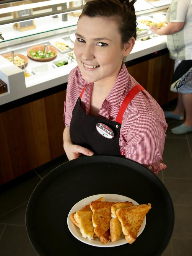 Staff member Felicity Paddison with Sizzler’s famous cheese toast. Picture: Chris Higgins