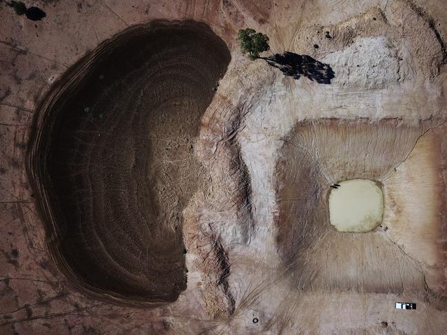 Farmers Richard and Diane Darcy at one of their many empty dams on their Tullamore farm. Picture: Jonathan Ng