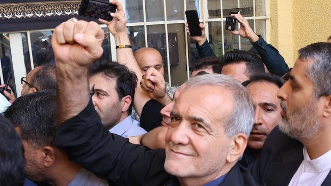 Iranian reformist candidate Masoud Pezeshkian reacts after casting his ballot during the presidential runoff elections in Shareh Qods, west of Tehran on July 5, 2024. Masoud Pezeshkian, Iran's only reformist candidate in the latest presidential election, has risen from relative obscurity to become the ninth president of the Islamic republic on July 6, 2024.  Pezeshkian, 69, won around 53.6 percent of the vote in a runoff election against the ultraconservative Saeed Jalili. (Photo by ATTA KENARE / AFP)