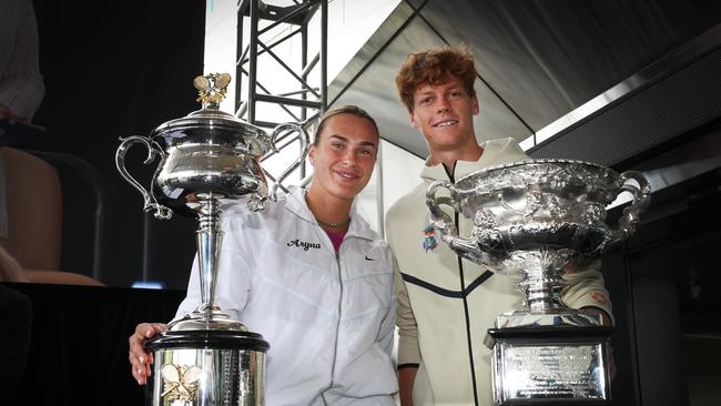 Reigning champions Aryna Sabalenka and Jannik Sinner with the official trophies. Picture: David Caird