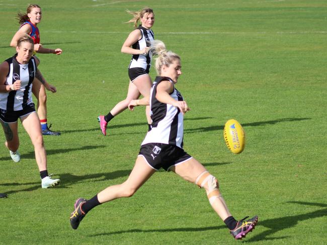 Claremont's Natalie Smedley gets a kick away during the match against Huonville in the SFLW Premiership League. Picture: Jake Garland