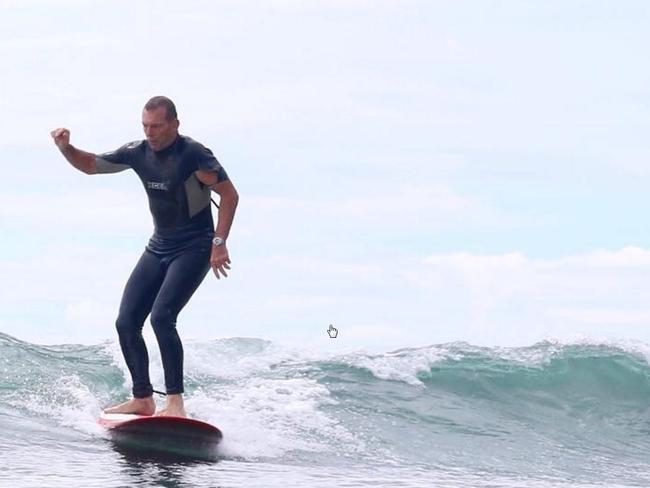Tony Abbott on a wave at Tea Tree Bay Noosa with another person Ivy Thomas. photo from bailey eldering instagram