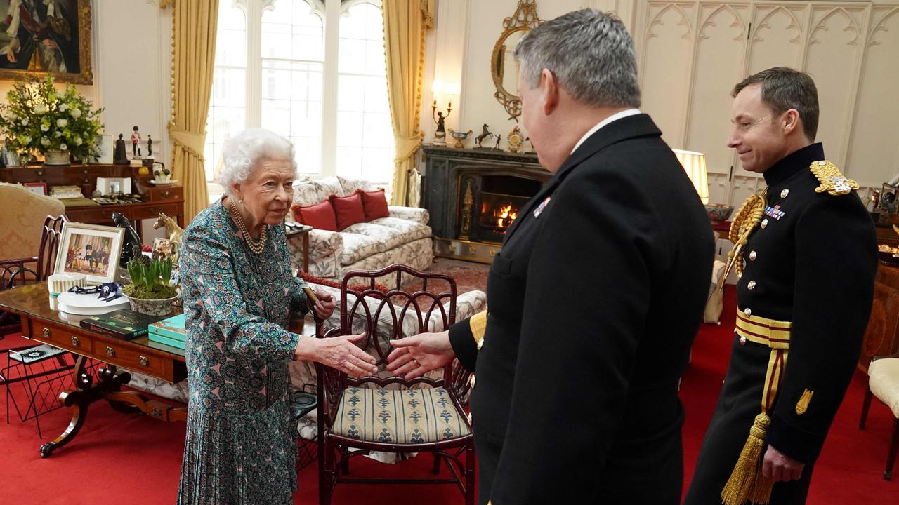 The Queen welcomes outgoing Defence Service Secretaries Rear Admiral James Macleod (R) and incoming Defence Service Secretaries Major General Eldon Millar (C) on February 16. Picture: Steve Parsons/AFP