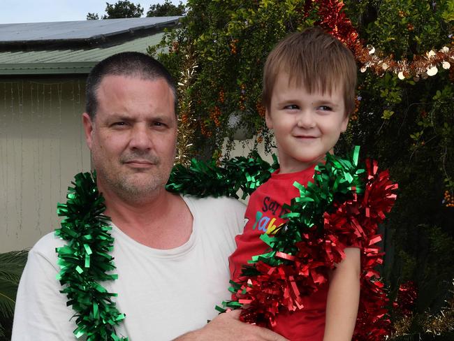 Andrew Tett with son Xavier Tett, 4, concerned by the damage and theft of their Christmas Lights, Deception Bay. Picture: Liam Kidston