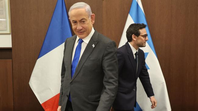 Benjamin Netanyahu and French Foreign Minister Stephane Sejourne take their seats before their meeting in Jerusalem on Tuesday. Picture: AFP