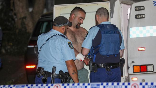 Jason Hristovski is led to a waiting police van by officers. Picture: Dean Asher