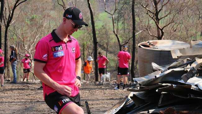 Sydney Sixers player Jordan Silk takes a moment to reflect on the tragic situation at fire ravaged Nymboida during a team visit ahead of their BBL09 fixture with Adelaide Strikers at C.ex Coffs International Stadium.