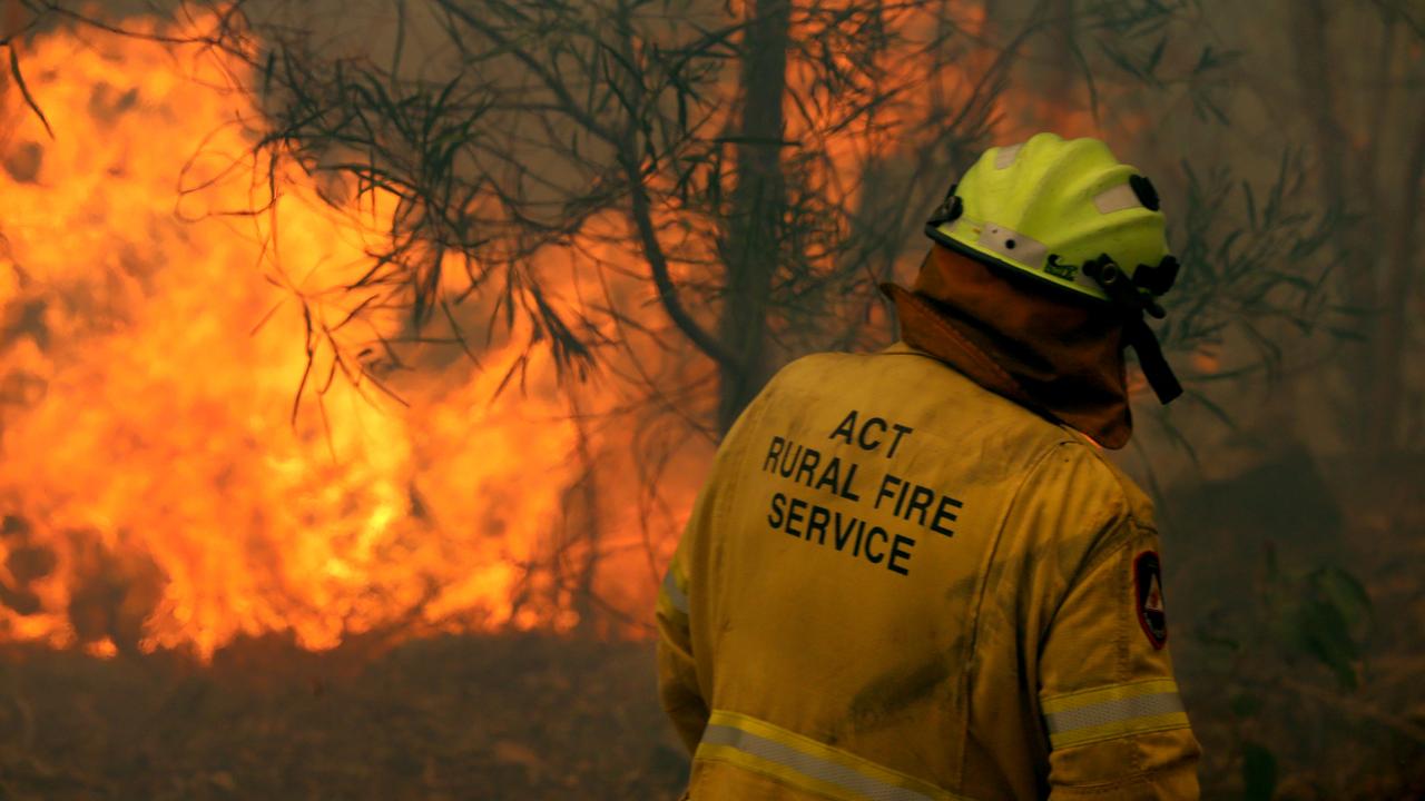 A strike team from the ACT RFS perform bushfire property protection at Telegraph Point north of Port Macquarie on the NSW mid north coast. Picture: Nathan Edwards.