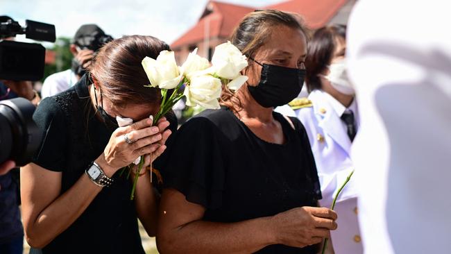 Weeping, grief-stricken families gathered on Friday outside a Thai child care centre where an ex-policeman killed nearly two dozen young children in one of Thailand's worst mass killings. Picture: AFP