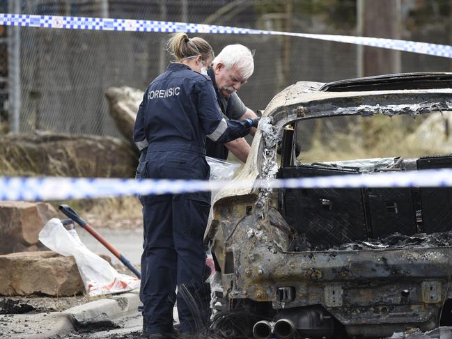 Police investigate a burnt out car on Northbourne Rd Campbellfield believed to be linked to an overnight fatal shooting at a house on nearby Gentles Ave. Picture: Andrew Henshaw