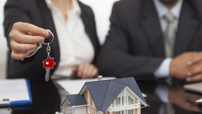 Female real estate agent giving the house key