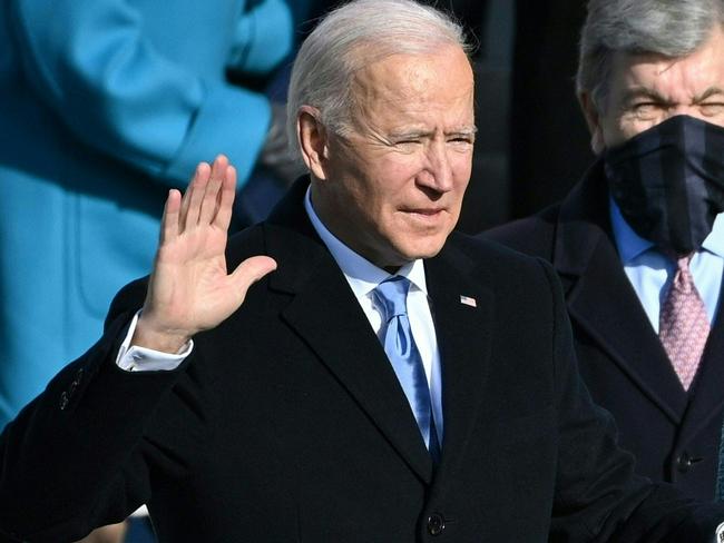 (FILES) In this file photo taken on January 20, 2021, Joe Biden, flanked by incoming US First Lady Jill Biden, takes the oath of office as the 46th US President during the swearing-in ceremony at the US Capitol in Washington, DC. - Never before has a sitting US president faced 80 candles on a birthday cake -- and the milestone that Joe Biden reaches on November 20, 2022, has undeniable ramifications as he ponders running again in 2024. Biden himself jokes about the big 8-0. "I can't even say the age I am going to be," he said on MSNBC. "I can't even get it out of my mouth. And he brushes off questions about whether he should seek reelection that would put him in power until aged 86, responding with two words: "Watch me." (Photo by Brendan SMIALOWSKI / AFP)